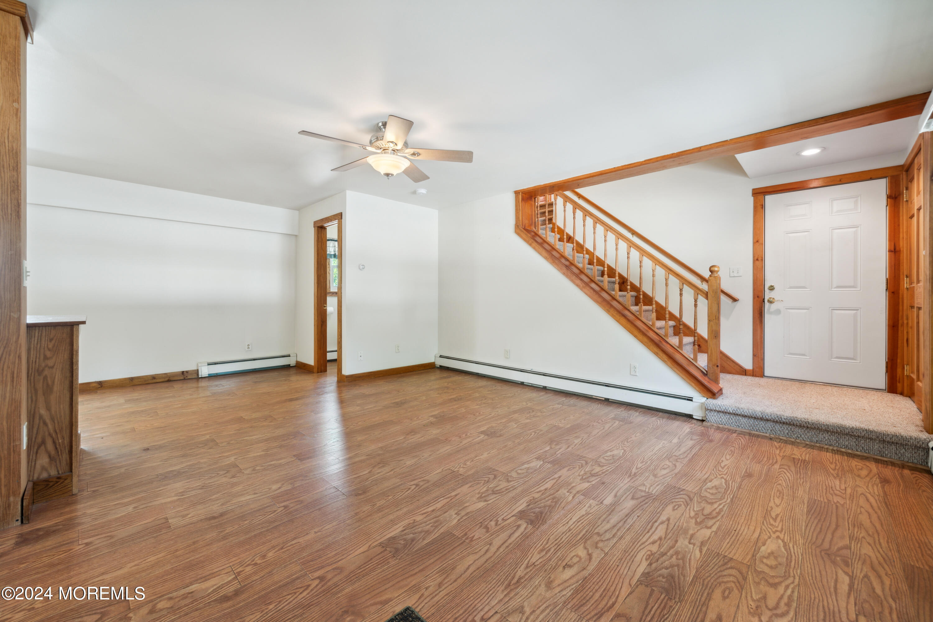 232 11th Street Barnegat, NJ 08005 - Photo 6 of 39 a view of an empty room with a window and wooden floor