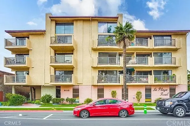 a front view of a residential apartment building with a yard
