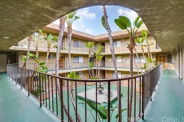 a view of a brick house with a iron stairs