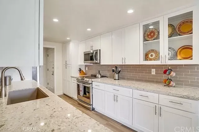 a kitchen with a sink cabinets and appliances