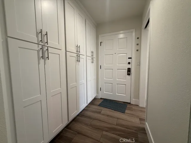 a view of a hallway with wooden floor