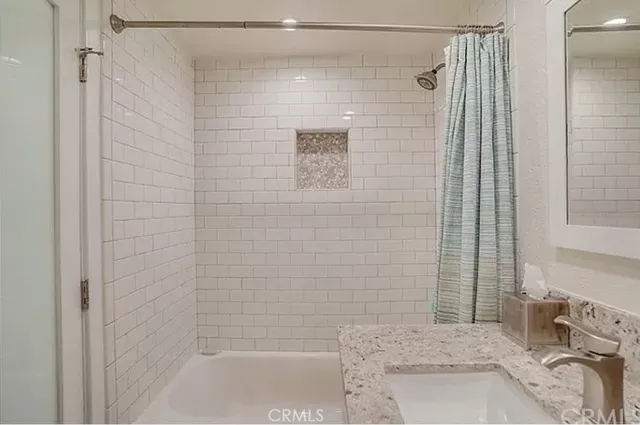 a bathroom with a shower and a sink