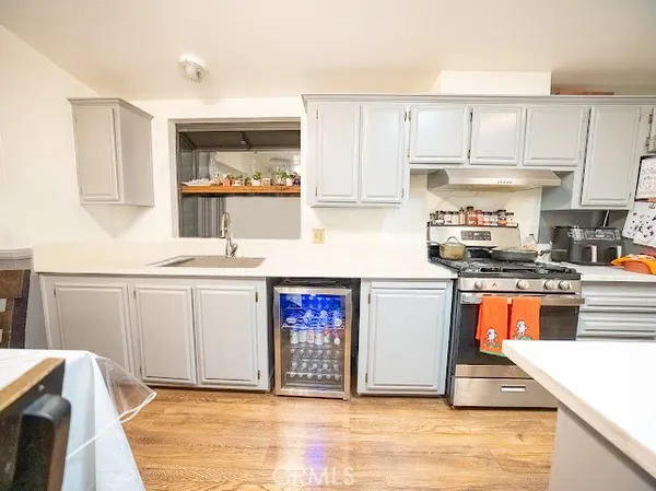 a kitchen with stainless steel appliances granite countertop a refrigerator and a stove top oven