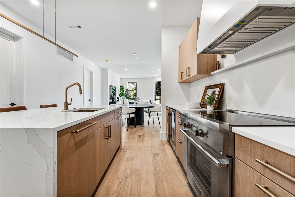 1114 Beacon Street, Unit 206 Newton, MA 02461 - Photo 11 of 39 a kitchen with stainless steel appliances a sink and a stove