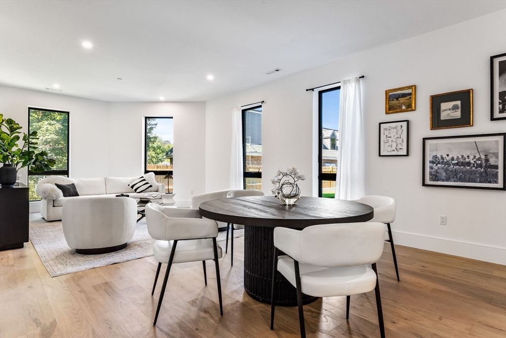 1114 Beacon Street, Unit 206 Newton, MA 02461 - Photo 2 of 39 a view of a dining room with furniture and wooden floor