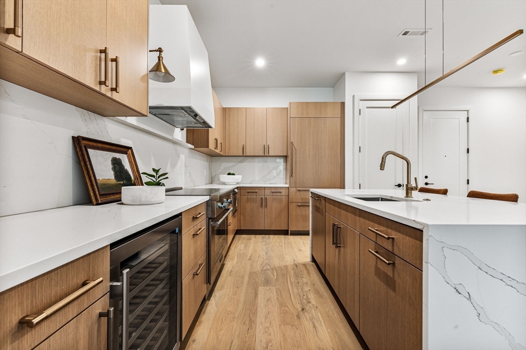 1114 Beacon Street, Unit 206 Newton, MA 02461 - Photo 10 of 39 a kitchen with counter top space a sink a stove and cabinets