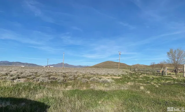 a view of a road with wooden fence