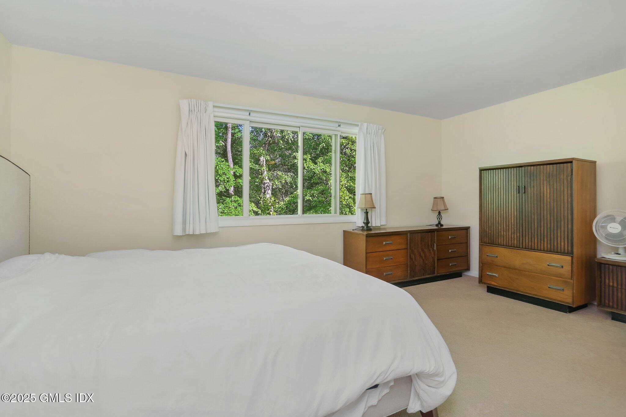 74 Silo Circle Riverside, CT 06878 - Photo 15 of 29 a bedroom with a bed and a window