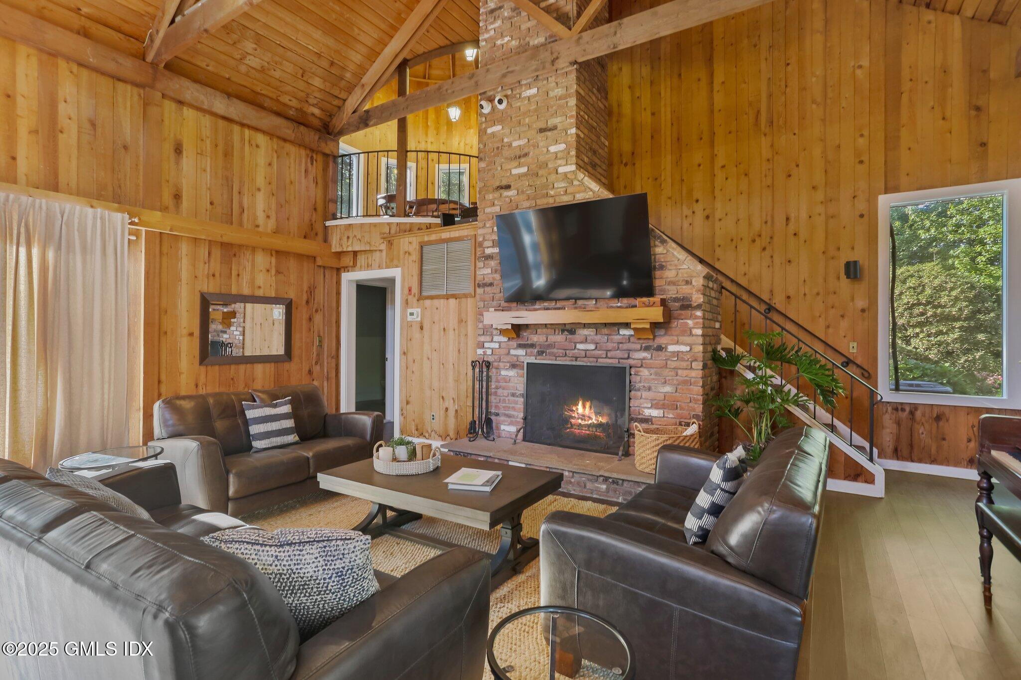 74 Silo Circle Riverside, CT 06878 - Photo 25 of 29 a living room with furniture a flat screen tv and a fireplace