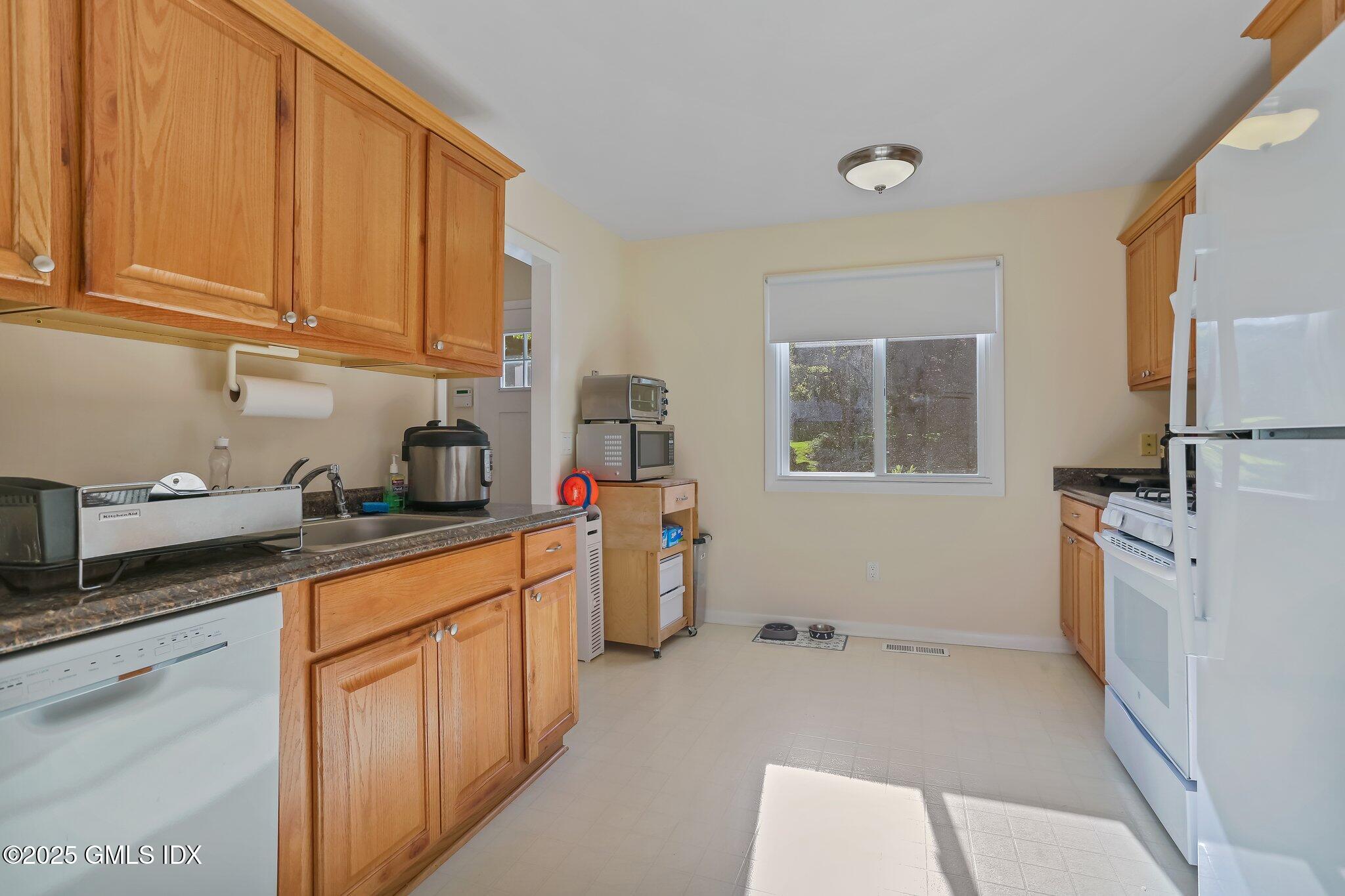 74 Silo Circle Riverside, CT 06878 - Photo 5 of 29 a kitchen with a sink stove and cabinets