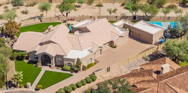 an aerial view of a house with swimming pool and porch
