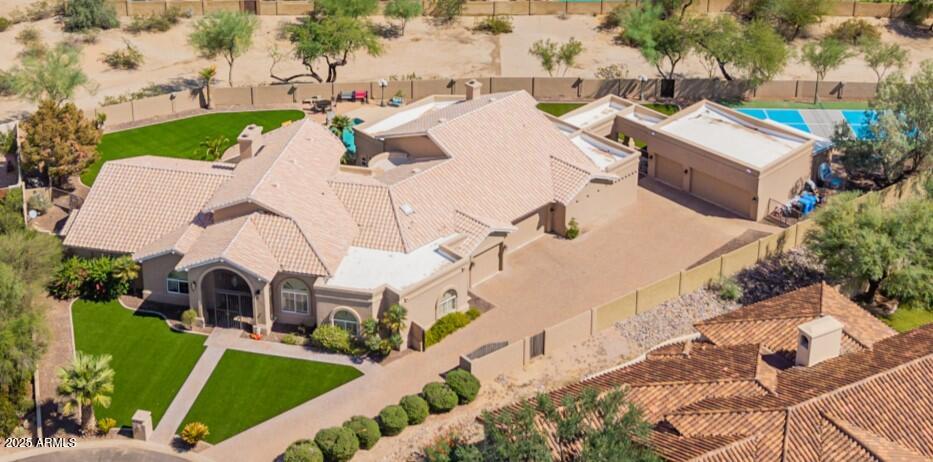 an aerial view of a house with swimming pool and porch