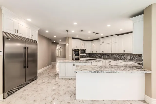 a view of kitchen with kitchen island a sink stainless steel appliances and cabinets