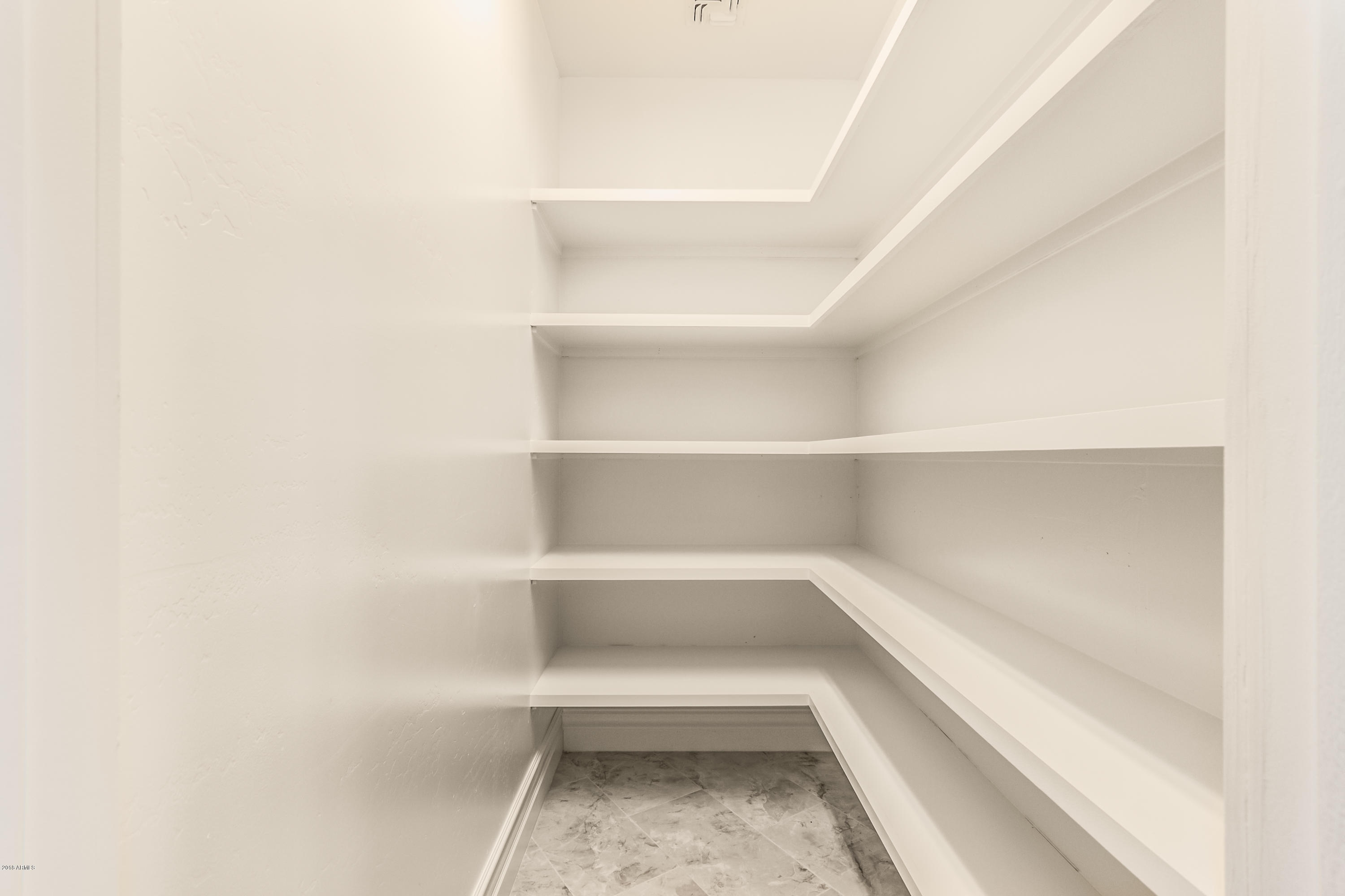 3332 East Cherokee Street Phoenix, AZ 85044 - Photo 13 of 47 a view of a room with shelves