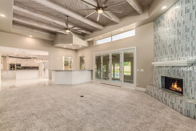 a view of empty room with a fireplace and fan