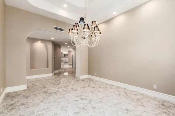 a view of a hallway with a chandelier