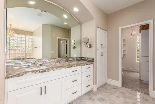 a bathroom with a granite countertop sink mirror and double