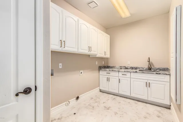 a kitchen with granite countertop a sink and cabinets
