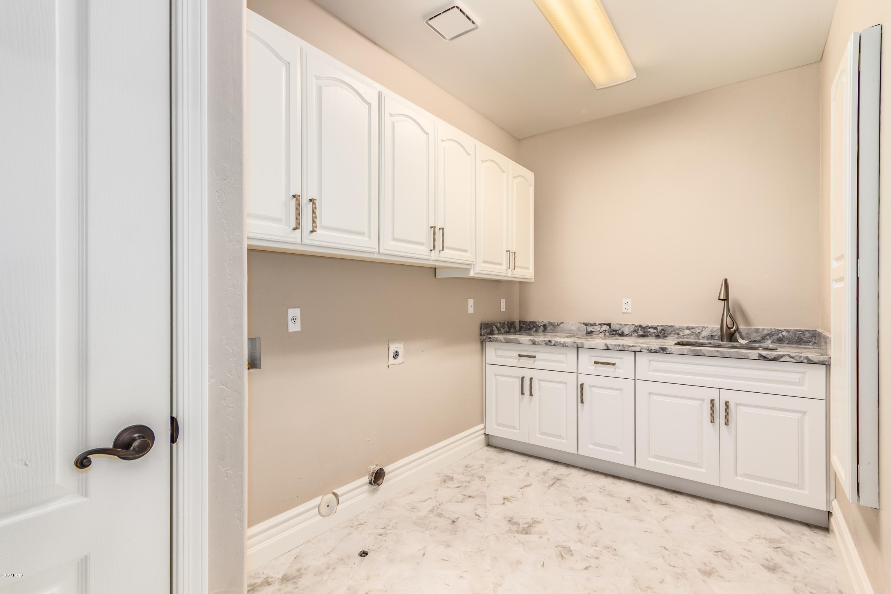3332 East Cherokee Street Phoenix, AZ 85044 - Photo 31 of 47 a kitchen with granite countertop a sink and cabinets