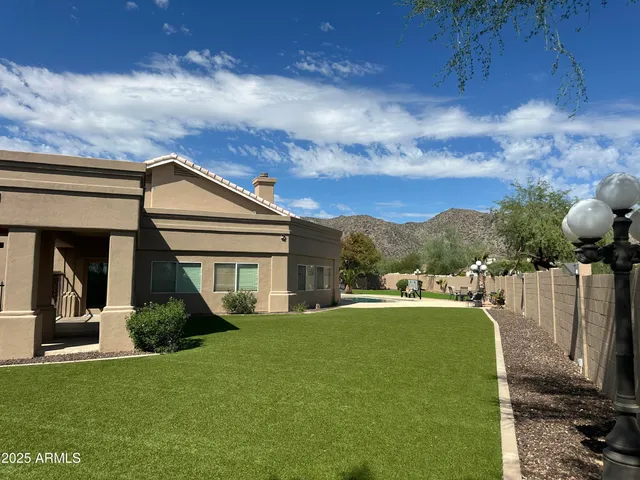 a view of a house with backyard and porch