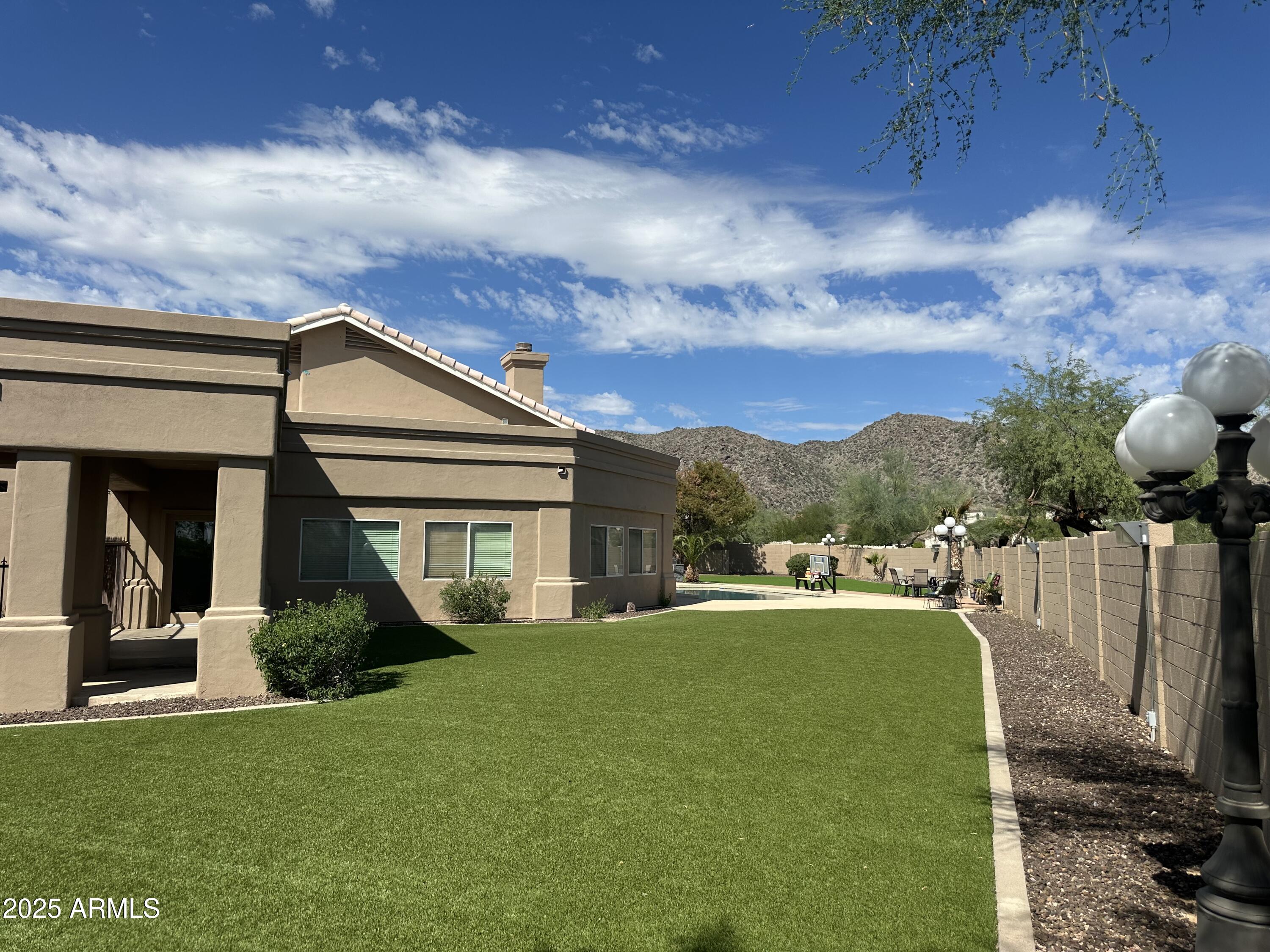 3332 East Cherokee Street Phoenix, AZ 85044 - Photo 37 of 47 a view of a house with backyard and porch