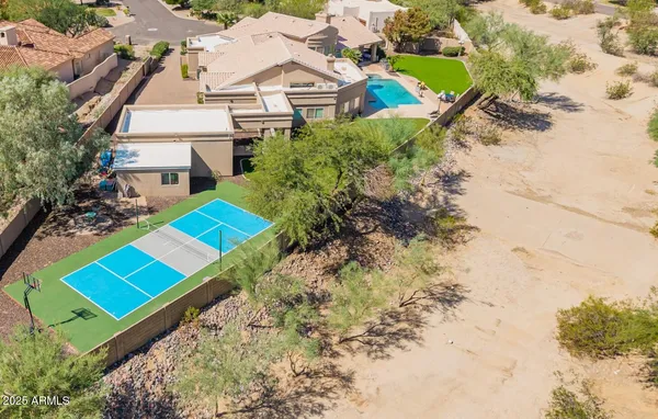 an aerial view of a house with a yard and pool