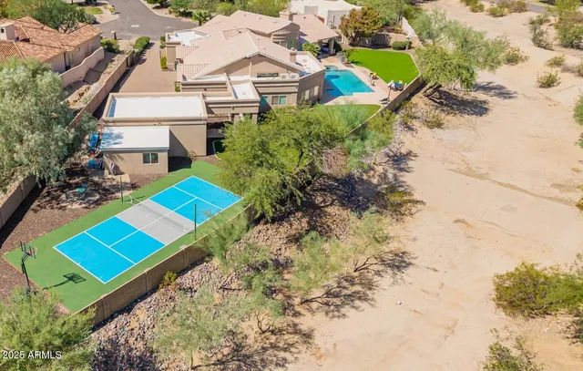 an aerial view of a house with a yard and pool