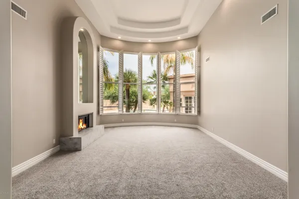 an empty room with windows and city view