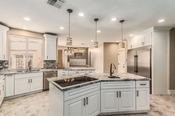 a kitchen with a sink stove and refrigerator