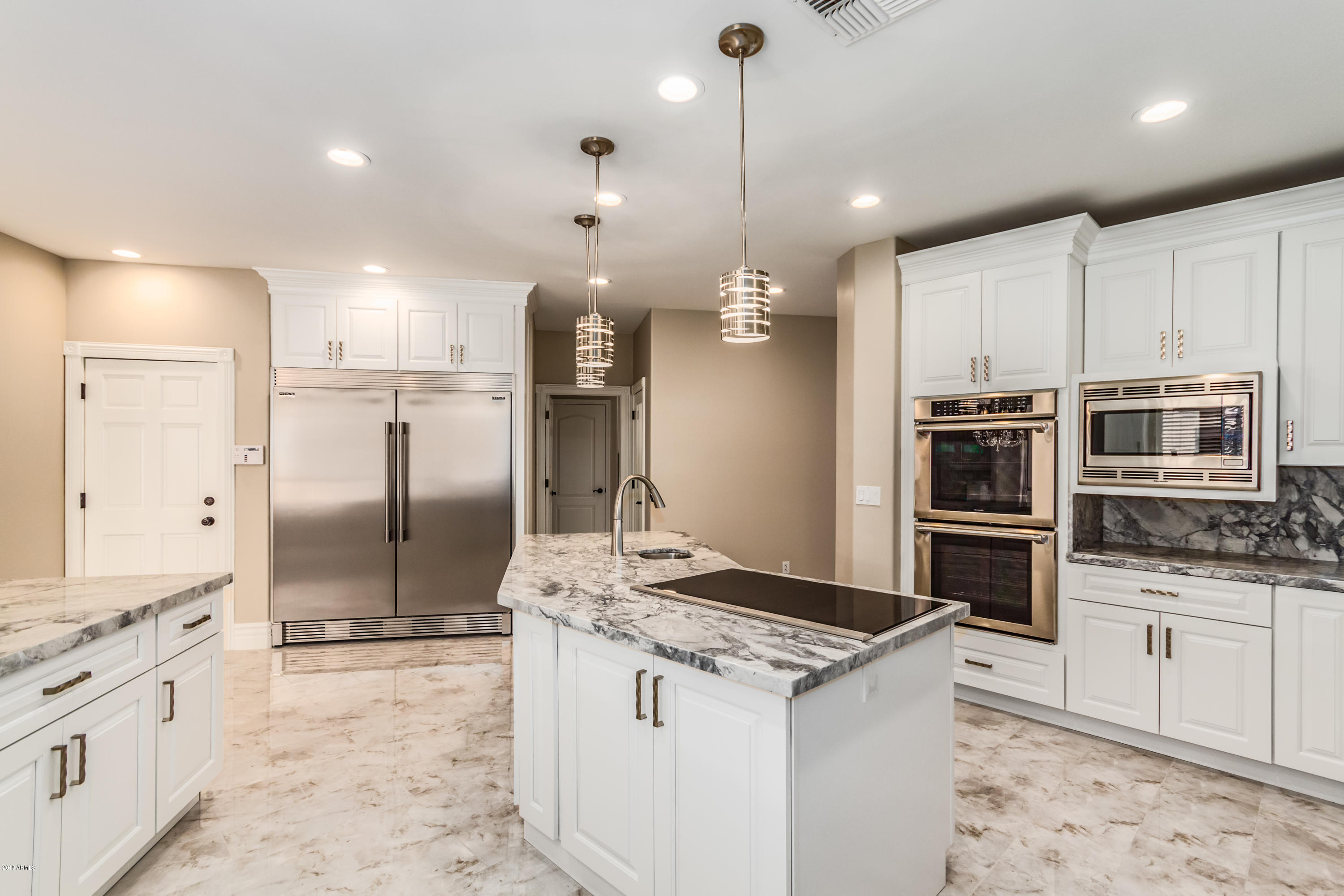 3332 East Cherokee Street Phoenix, AZ 85044 - Photo 9 of 47 a kitchen with stainless steel appliances kitchen island granite countertop a sink a stove and a refrigerator