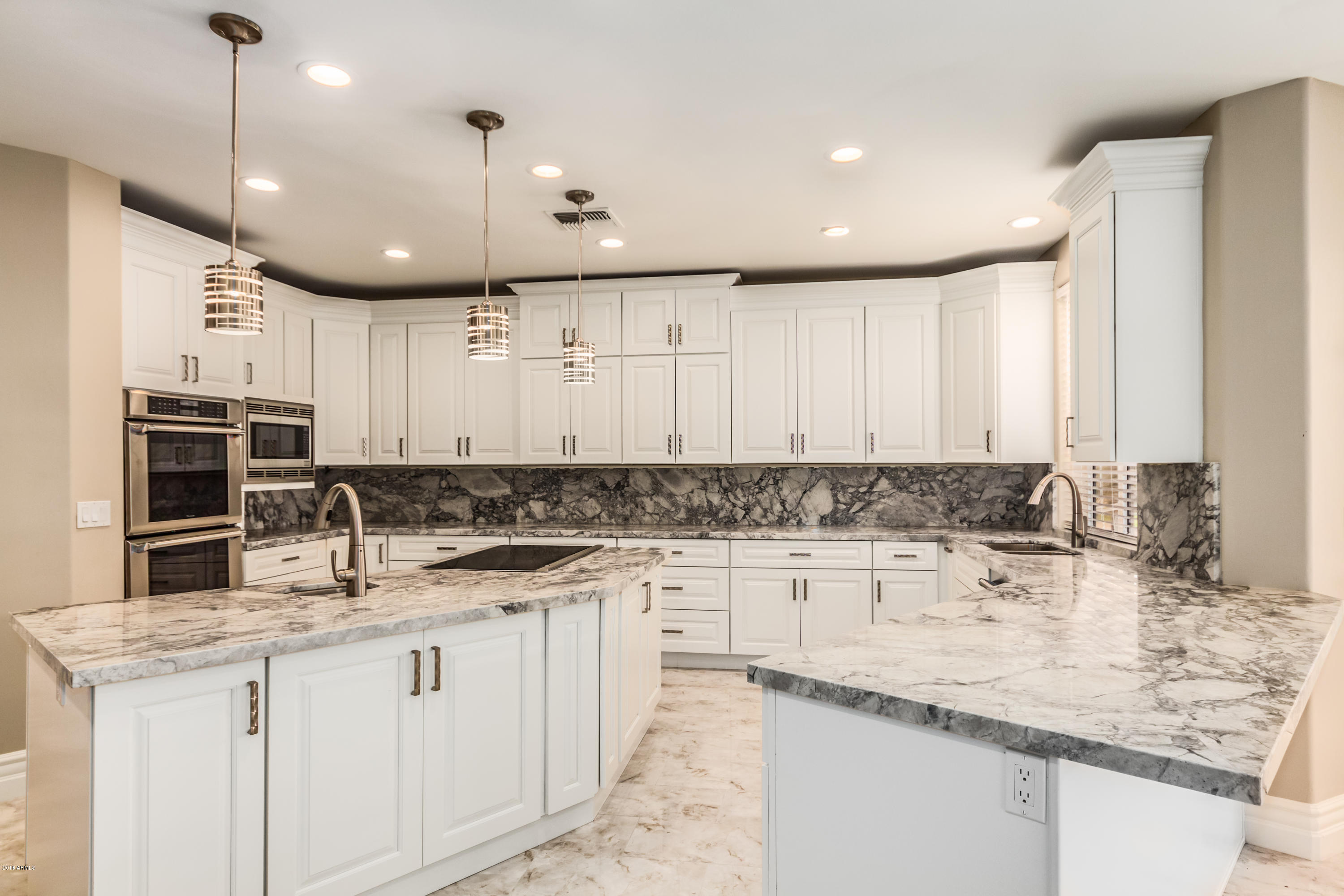3332 East Cherokee Street Phoenix, AZ 85044 - Photo 10 of 47 a kitchen with kitchen island granite countertop a sink a counter space appliances and cabinets