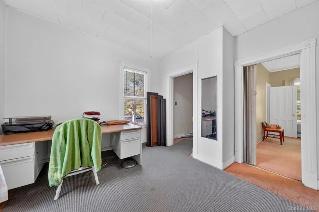 a living room with furniture and a balcony
