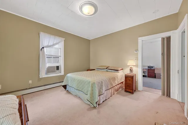 a spacious bedroom with a bed and a cabinets