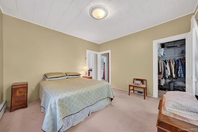 a bedroom with a bed and a television