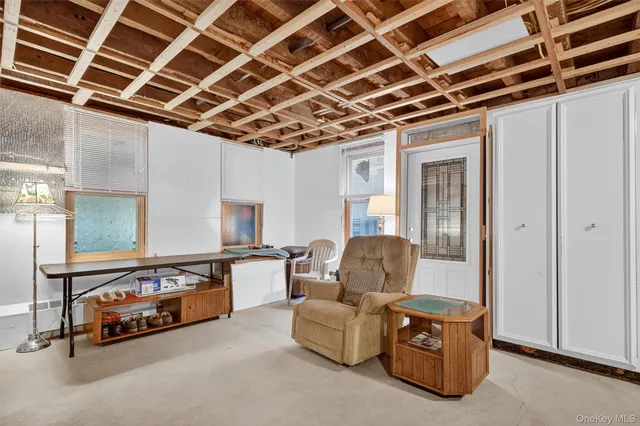 a living room with furniture with a flat screen tv and furniture