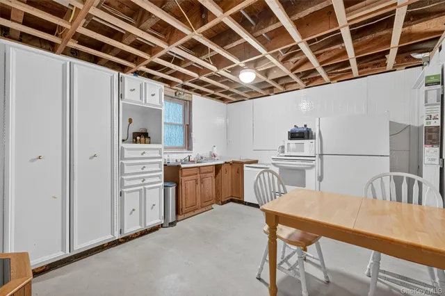 a view of a kitchen with furniture and wooden floor