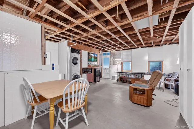 a view of a dining room with furniture a fireplace and wooden floor