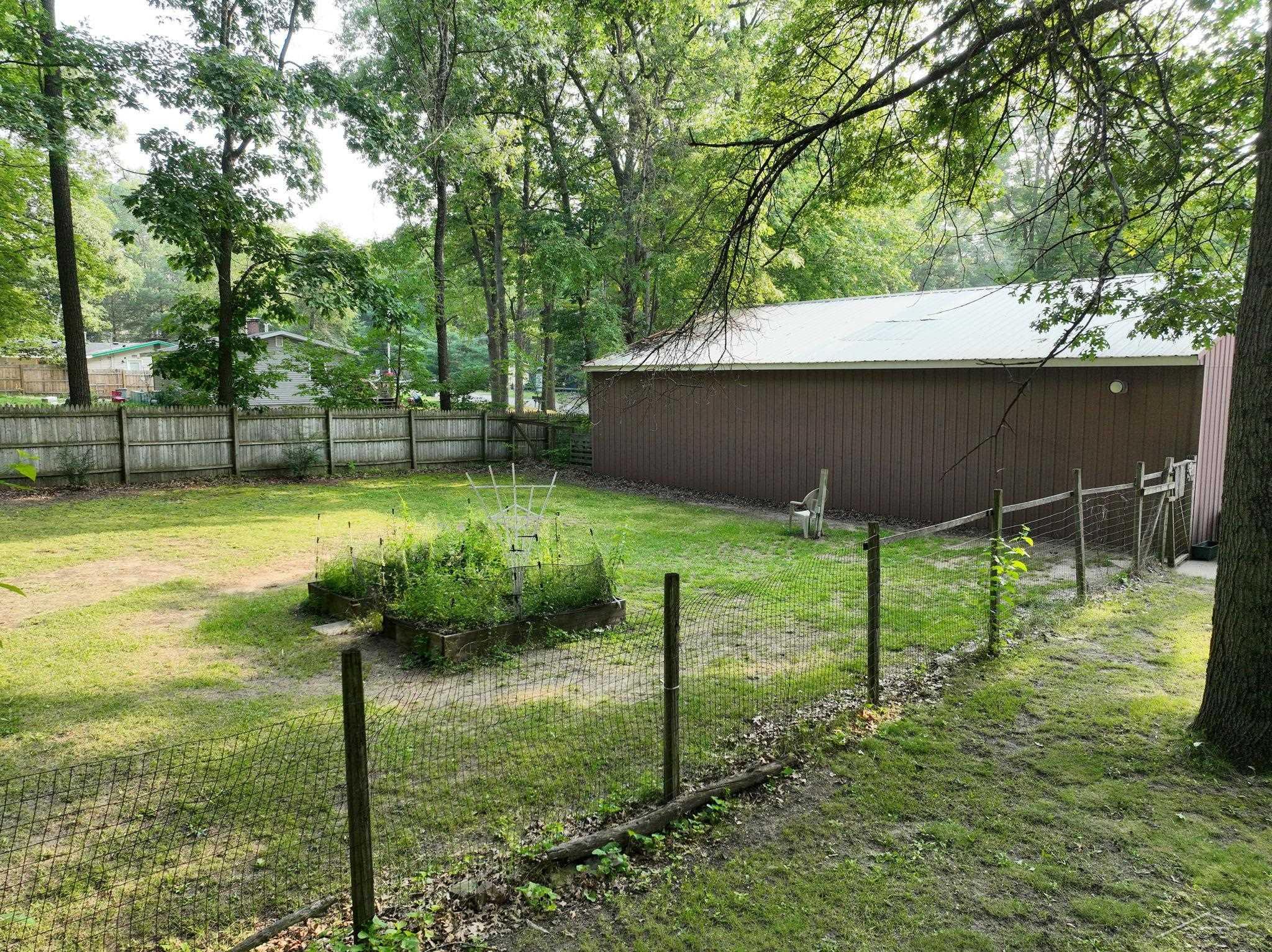 670 Lone Pine Road Harrison, MI 48625 - Photo 9 of 34 This large part of the backyard is fully fenced and great for a protected garden, extra storage or a dog run.