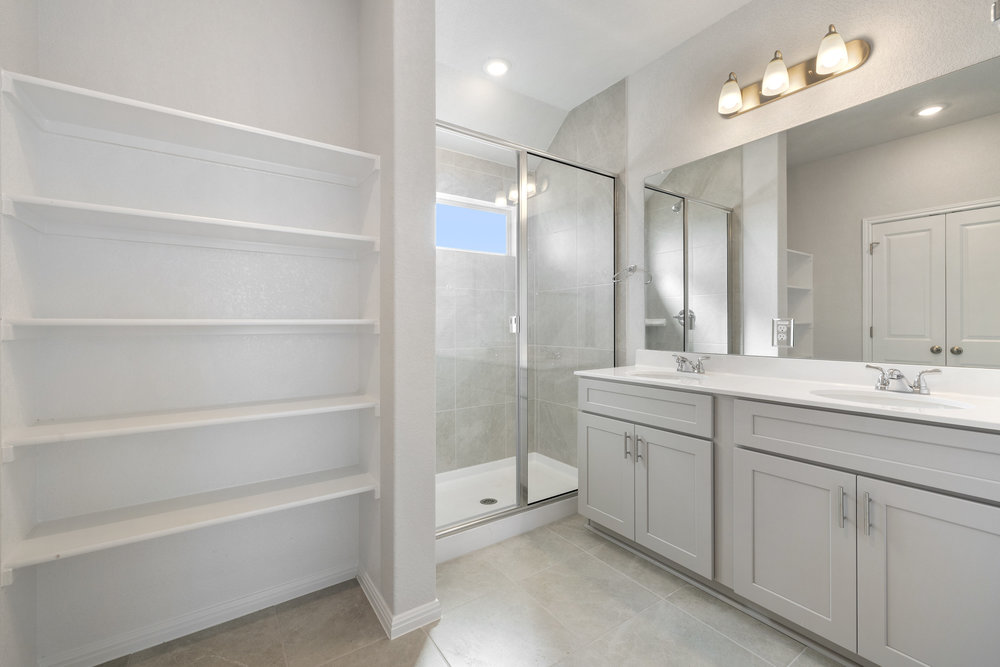 372 Glocken Lane Kyle, TX 78640 - Photo 12 of 37 a bathroom with a shower sink double vanity and mirror