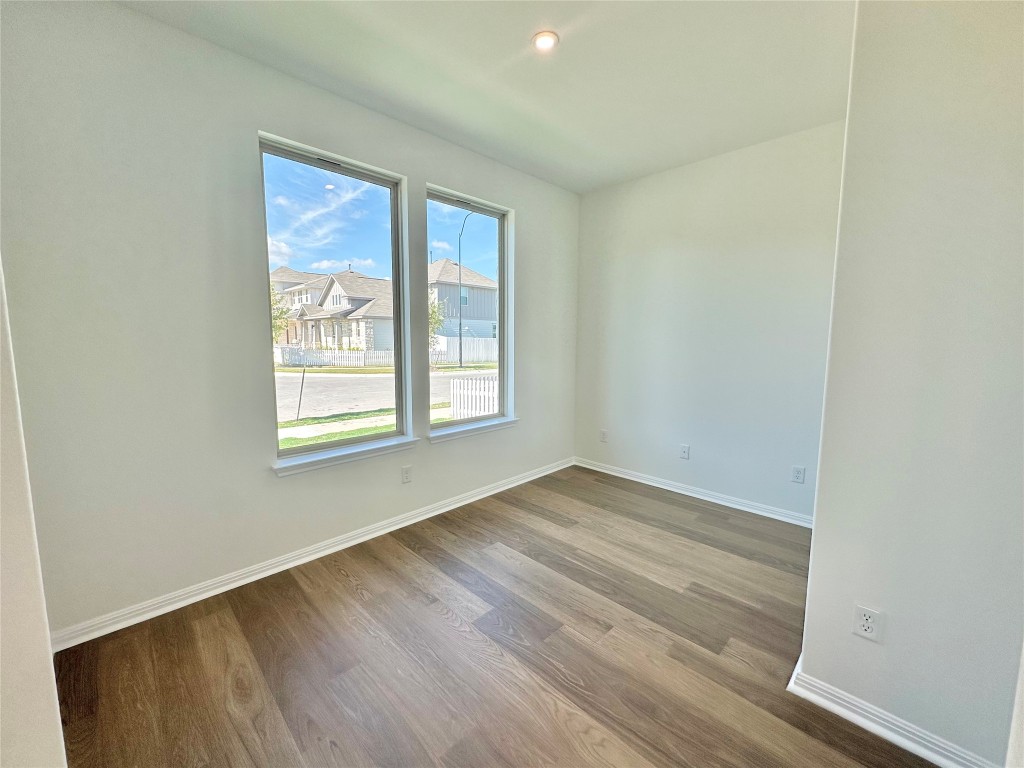 372 Glocken Lane Kyle, TX 78640 - Photo 13 of 37 an empty room with wooden floor and windows