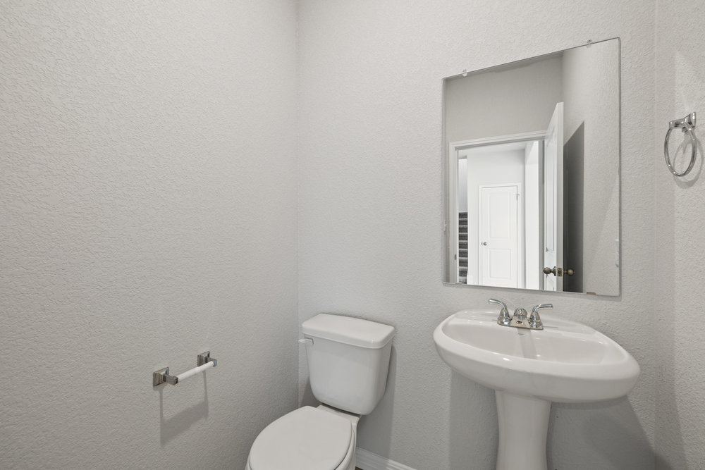 372 Glocken Lane Kyle, TX 78640 - Photo 19 of 37 a bathroom with a toilet sink and mirror