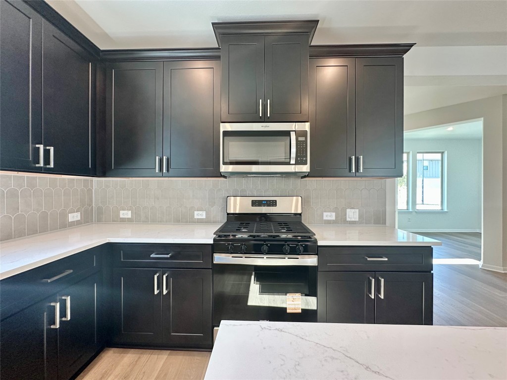 372 Glocken Lane Kyle, TX 78640 - Photo 8 of 37 a kitchen with a sink and a stove top oven