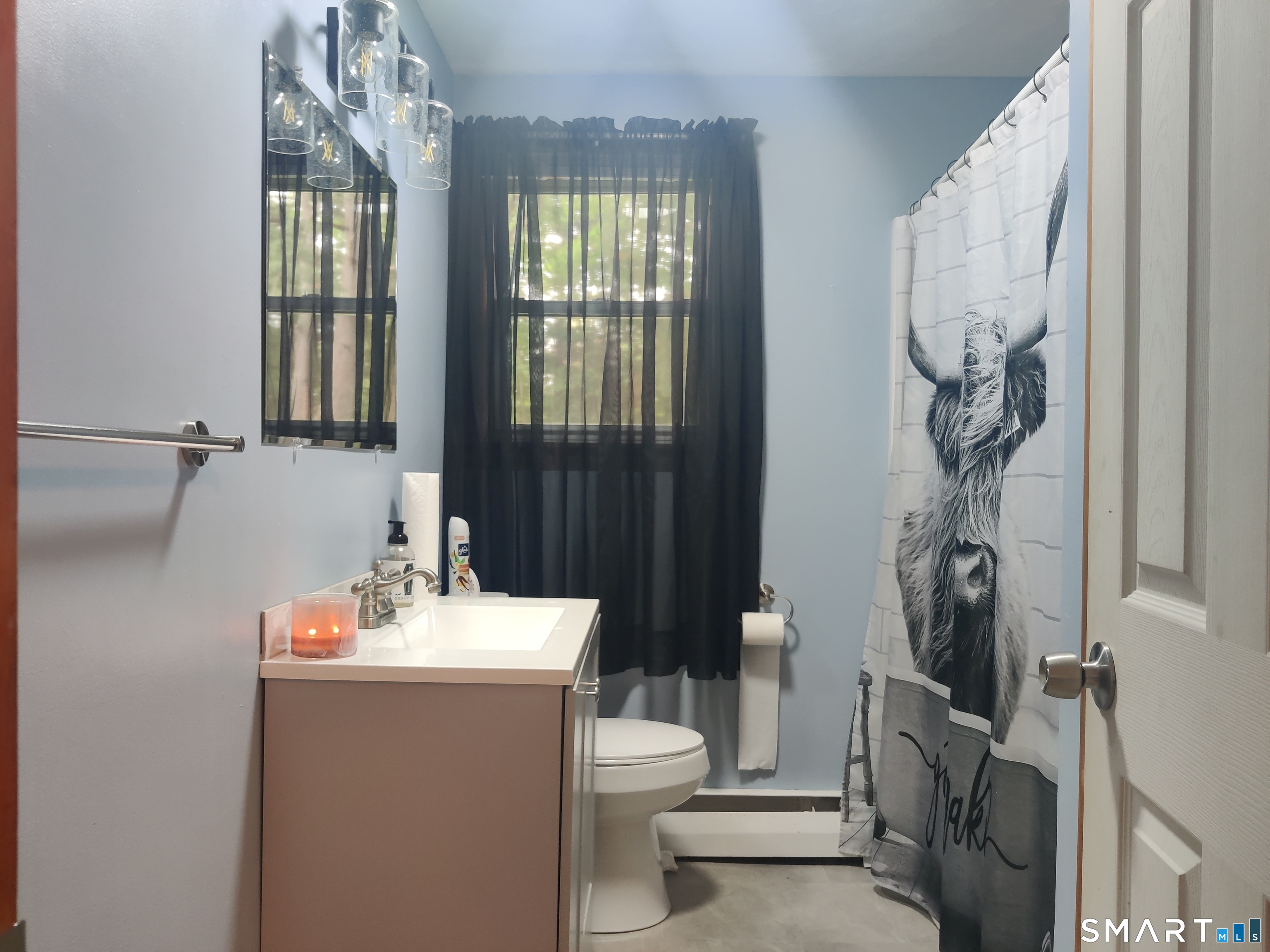 35 Brook Road Enfield, CT 06082 - Photo 6 of 25 a bathroom with a sink a toilet and shower curtain