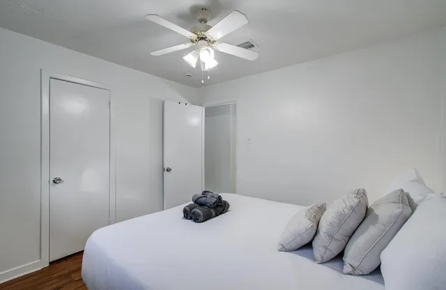 a bedroom with a bed and a chandelier