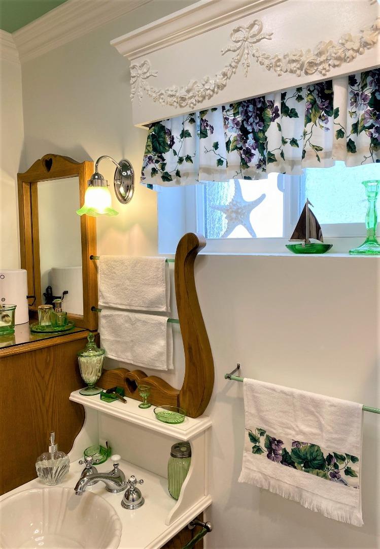 621 McClellan Avenue, Unit STUDIO Monterey, CA 93940 - Photo 23 of 32 a bathroom with a sink and a mirror