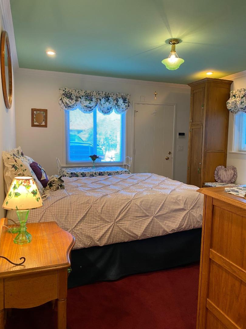 621 McClellan Avenue, Unit STUDIO Monterey, CA 93940 - Photo 8 of 32 a bed sitting in a bedroom next to a window