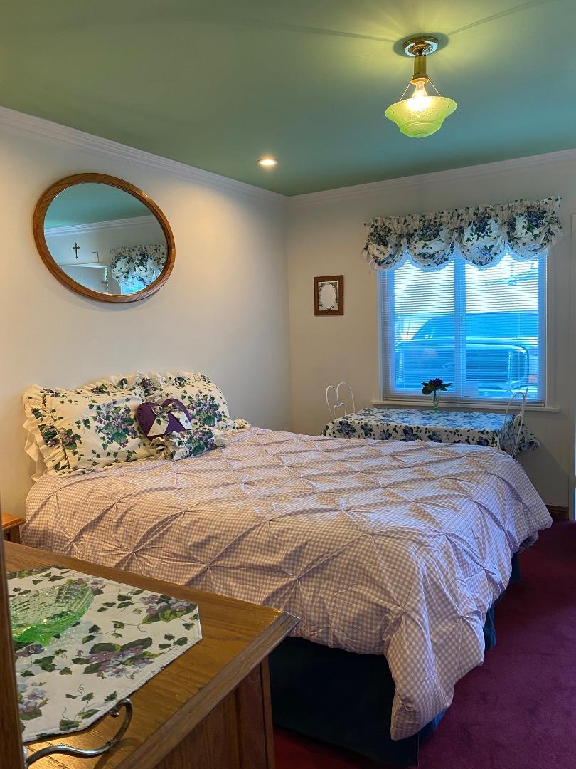 621 McClellan Avenue, Unit STUDIO Monterey, CA 93940 - Photo 10 of 32 a bedroom with a bed and a lamp