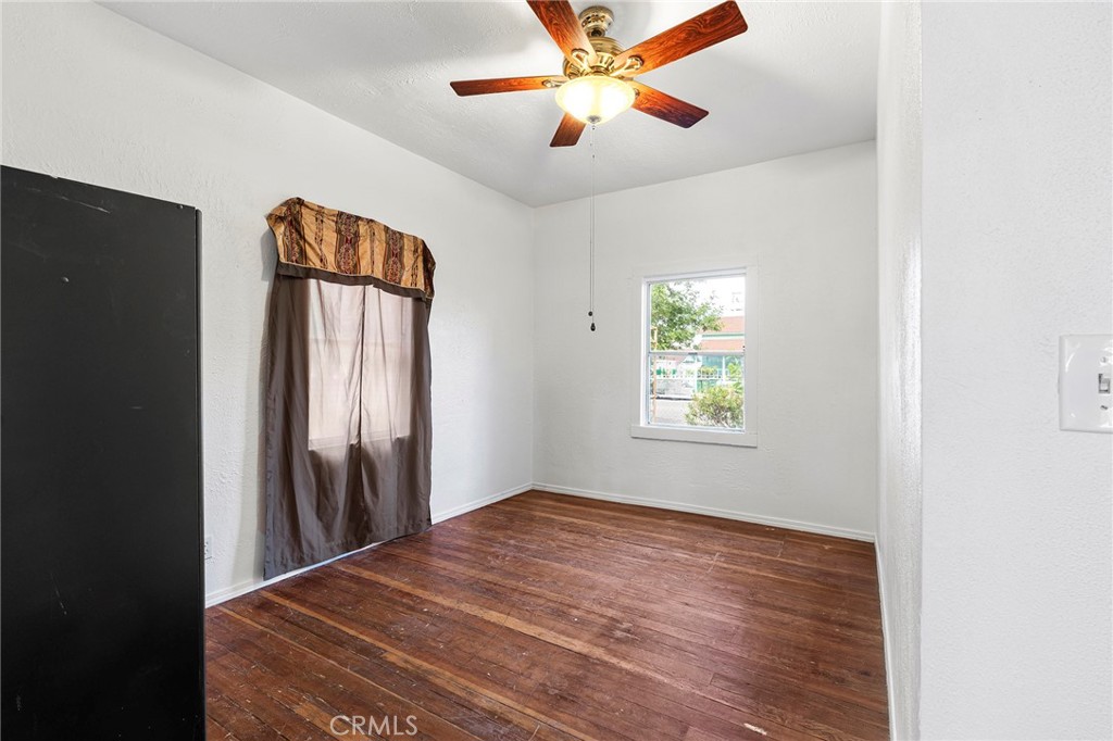 818 6th Street Corning, CA 96021 - Photo 17 of 32 a view of empty room with wooden floor and fan