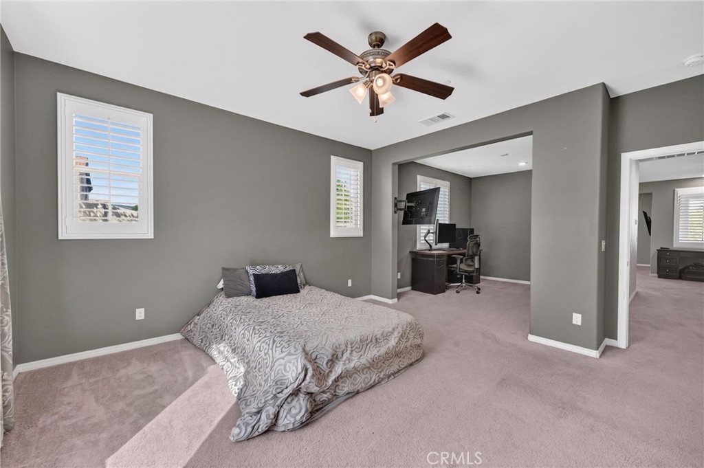 23347 Crystal Way Wildomar, CA 92595 - Photo 47 of 109 a bedroom with a large bed and a chandelier