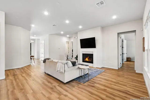 a living room with furniture a fireplace and a flat screen tv